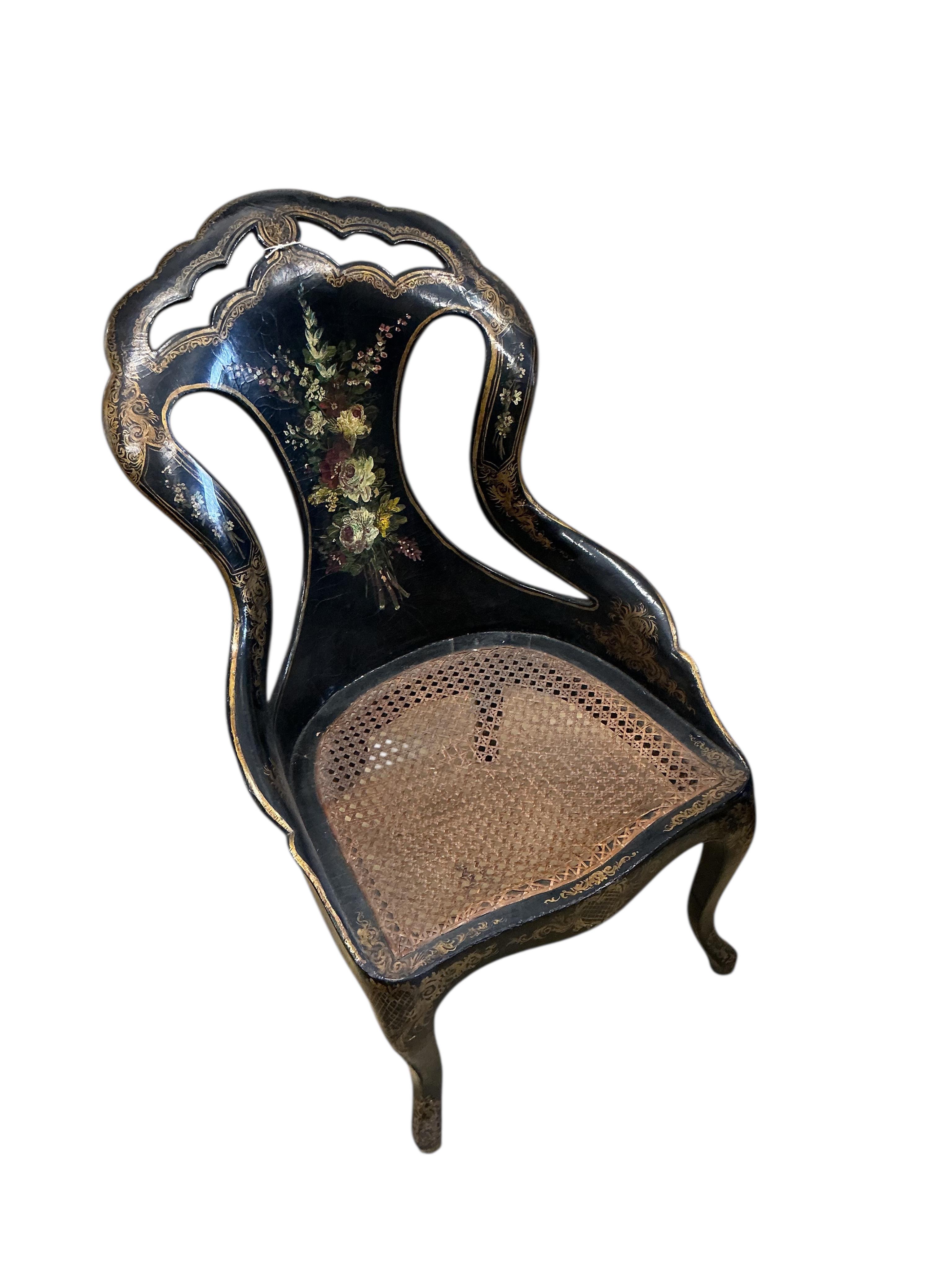 A Victorian mother of pearl inlaid papier-mâché oval tilt top wine table, width 58cm, height 67cm, and a similar cane seat chair